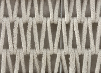 Close up of knitted linen basket in inverted chevron pattern. White basket with V shape chevron...