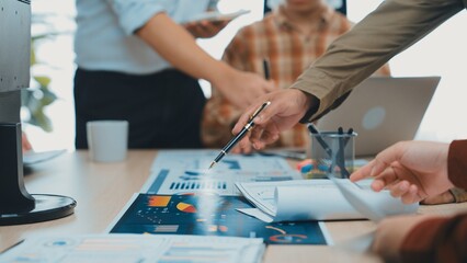 A dynamic office scene showcasing professionals engaged in a collaborative meeting, analyzing data and strategizing, reflecting teamwork and innovation in modern workplaces. SACTR