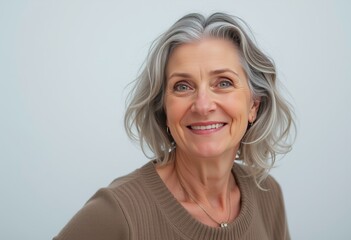 Fototapeta premium Senior Woman with Gray Hair and a Sweater Smiling for a Portrait