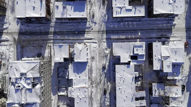drone view of a snow-covered city, top view, parallel street