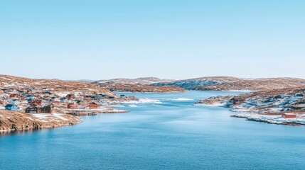 Fototapeta premium Scenic winter village nestled by a fjord