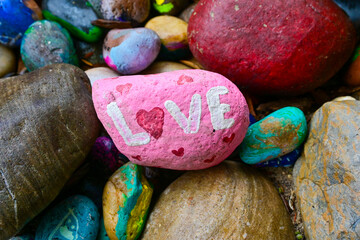  pink painted rock with love painted on it