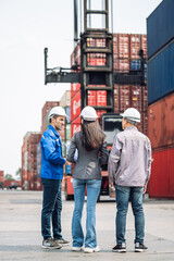 Fototapeta premium Team of industrial professionals inspecting cargo terminal, showcasing logistics, teamwork, and global transportation industry