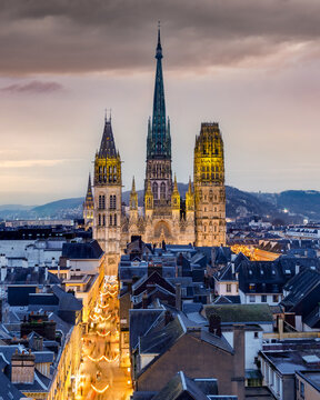 ROUEN, NORMANDIE, FRANCE - 2024: historic center, Great-Clock street, " Rue du Gros-Horloge ", cobbled pedestrian shopping street with Christmas tinsel decorations, towards Notre-Dame Cathedral