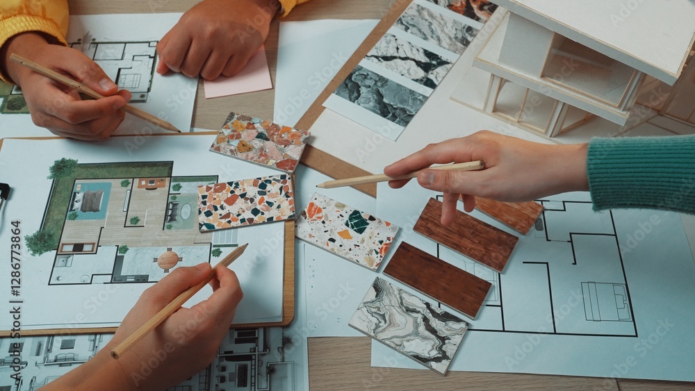 Poster a dynamic scene showcasing hands of individuals engaged in interior design work, analyzing materials