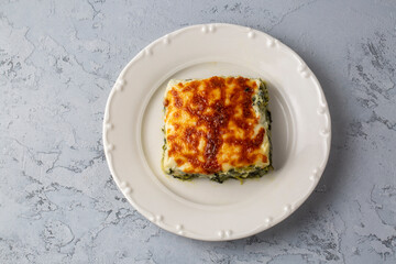Baked Spinach with cheese delicious Italian food cuisine. Spinach gratin.