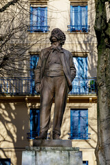 Naklejka premium ROUEN, NORMANDY, FRANCE - 2025: bronze statue of Gustave Flaubert, 19th century famous French writer, on Carmes Square