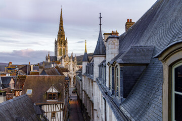 ROUEN, NORMANDY, FRANCE - 2025: elevated view on paved pedestrian Saint Romain street and Saint Maclou church, and roofs of half timbered medieval houses, historic center