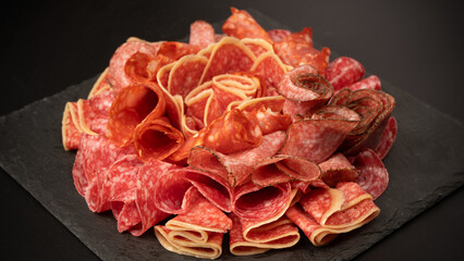 Different kinds of meat cuts on a board.