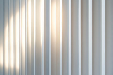 Obraz premium Sunlight casting shadows on vertical white wall panels interior space photography modern design close-up angle