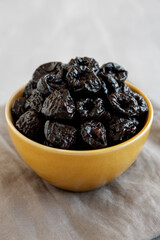 Raw Dried Plum Prunes in a Bowl, side view.
