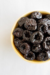 Raw Dried Plum Prunes in a Bowl, top view.
