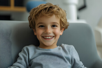 Smiling boy sitting on sofa at dental clinic