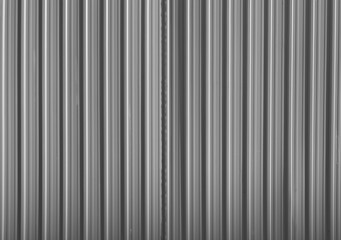 Corrugated gray shiny metal sheet. New and Modern silver grey background pattern. metal aluminum...