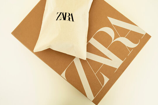 Alicante, Spain - January 30, 2025: Online shopping in Zara clothing store. Cardboard box with Zara logo and new shoes packed in reusable fabric bag. Zara is global fashion retailer of Inditex group