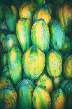 Ripe fruits of yellow papaya stacked at a local market of fruit and vegetable in Sri Lanka