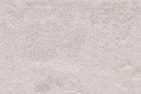 Neutral grey stone seamless repeating texture or background