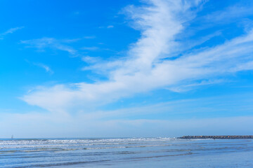 Dramatic Cloud Patterns over Tranquil Oceanside Waters