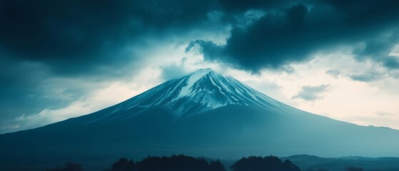 A dramatic view of a snow-capped mountain under brooding storm clouds, showcasing nature's raw power.