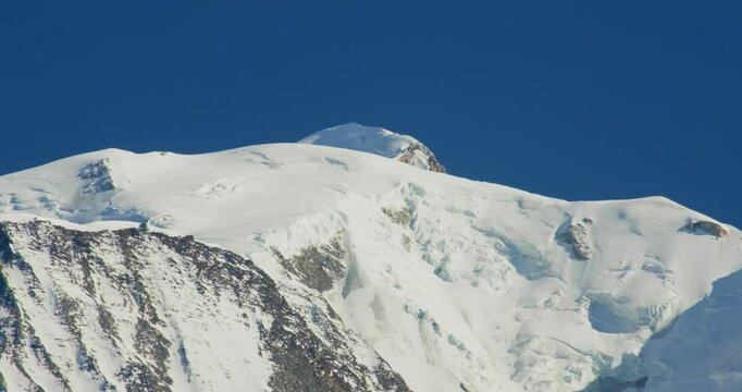 Scenic view of snow-covered mountain peal under a blue sky