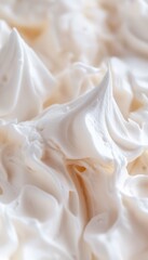 Close up of fluffy white frosting on tabletop, perfect for baking inspiration and culinary delight