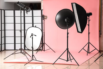 Pink background and modern equipment in photo studio