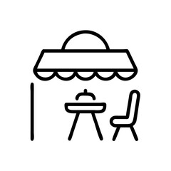 Outdoor seating area with a table and chair under an awning