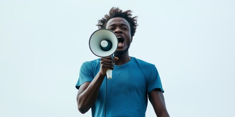 Voicing the Message: A Man in Blue T-Shirt Amplifying His Message with a Megaphone
