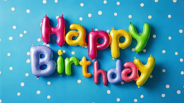 Bright happy birthday greeting and colorful balloons are arranged against a blue background with polka dots, creating a festive atmosphere