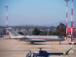 Private jet and police helicopter at airport