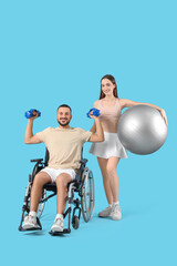 Obraz premium Young sporty man in wheelchair and with his wife on blue background