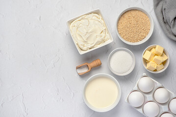 Blank food photography of raw ingredients of New York cheesecake, cream, soft cheese, sugar, butter, shortbread crumbs, vanilla