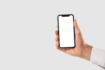 Man holding blank mobile phone on white background