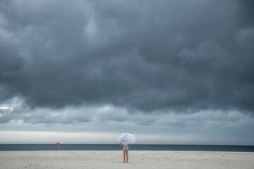 Girl with umbrella during monsoon in Maldives