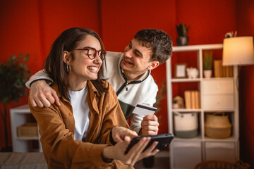 happy couple use credit card and mobile phone for online shopping