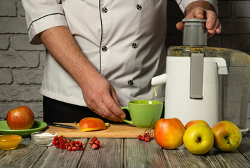 A chef skillfully prepares fresh apple juice using a juicer in a warm kitchen, surrounded by ripe fruits and colorful garnishes, conveying a sense of culinary creativity and passion