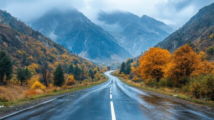 Fototapeta premium A winding road through mountains during a wet cloudy day