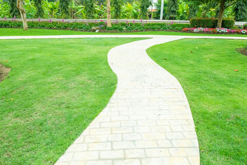 Walkway pathway s curve in public park,Lawn with curved paved garden path,Garden landscape design in flower garden,Selective focus,copy space.