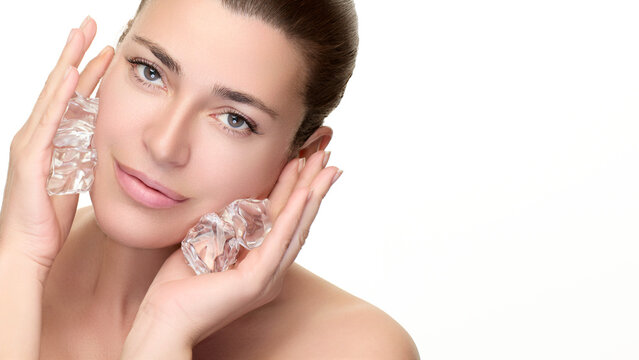 Woman using ice cubes for skincare, promoting beauty and wellness with natural treatments for fresh skin