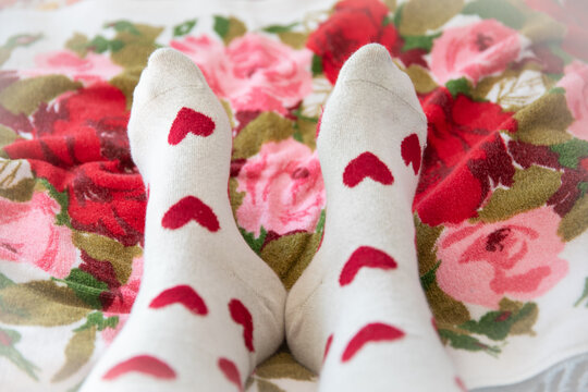 feet wearing socks with red hearts
