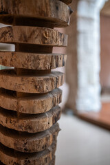 Close-up of stacked wooden slices reveals the natural patterns and textures on their surfaces, adding unique character to the contemporary interior space.