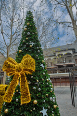 Christmas tree decorations with a huge orange bow.