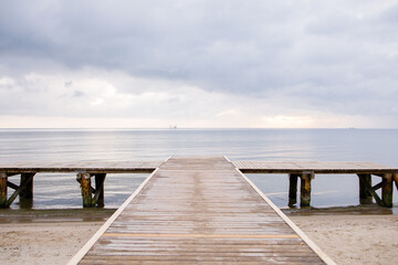 Obraz premium Wooden pier on empty beach by the Baltic sea in Sopot, Poland