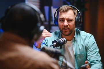 Podcast presenter having live discussion with man, streaming it for audience on internet...