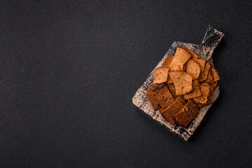 Crispy homemade brown bread chips with seeds and grains