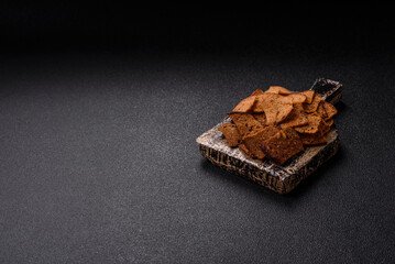 Crispy homemade brown bread chips with seeds and grains