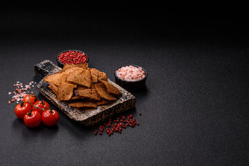 Crispy homemade brown bread chips with seeds and grains