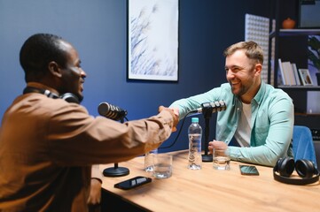 Podcast presenter having live discussion with man, streaming it for audience on internet...