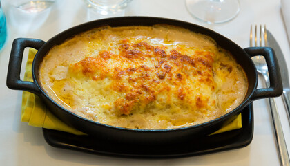 Baked lasagne with meat in bechamel sauce served in baking pan. Italian cuisine..