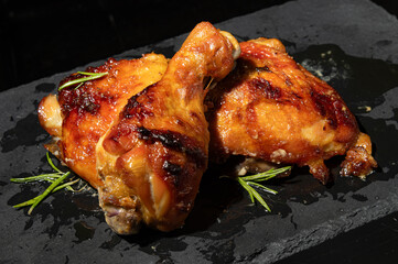 Juicy roasted chicken drumsticks, perfect for food blogs, restaurant menus, or recipe promotions. Delicious and tempting dark background